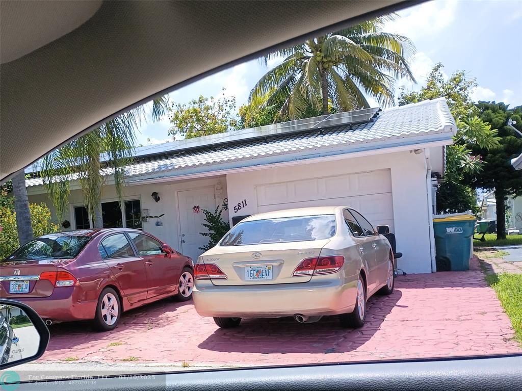 a front view of a house with car parked