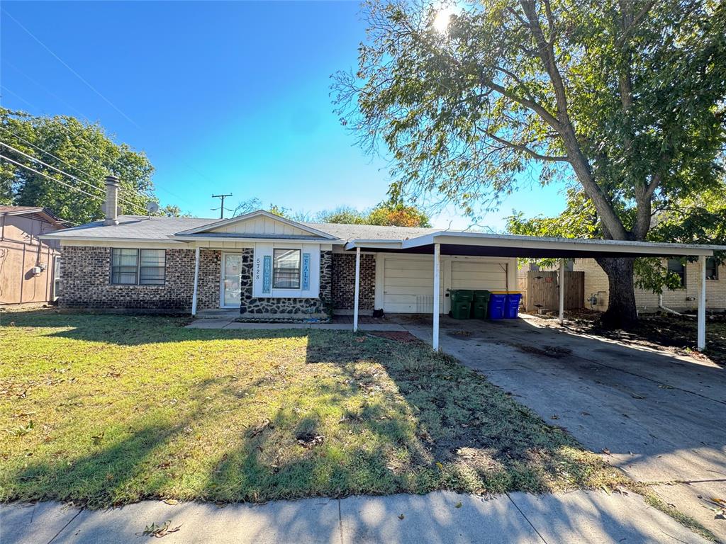 View of front of home with a front lawn and a carport