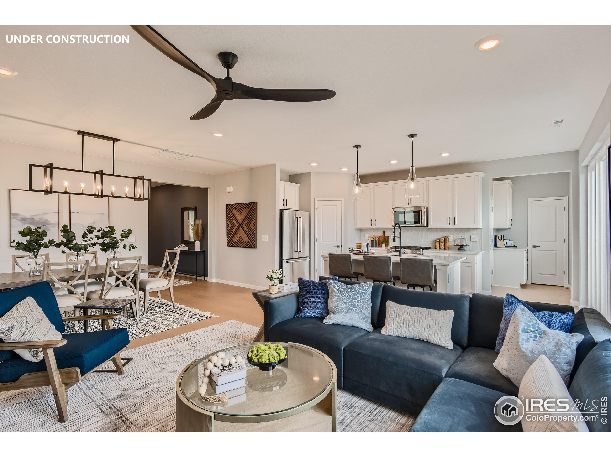 a living room with furniture and kitchen view