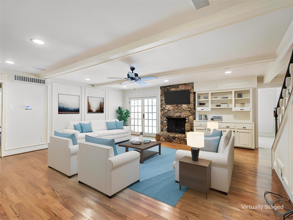 a living room with fireplace furniture and a flat screen tv