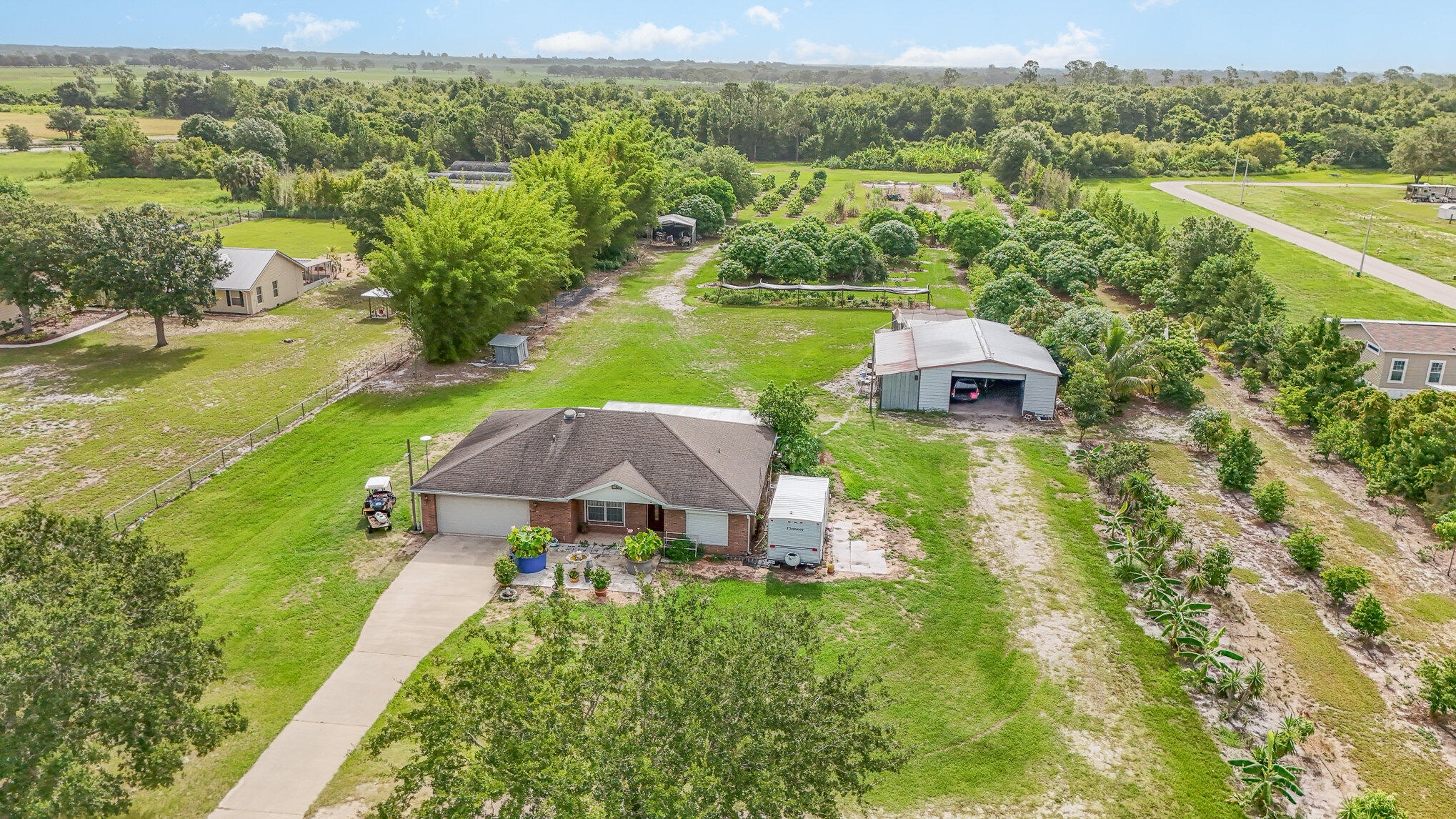 an aerial view of a house with backyard