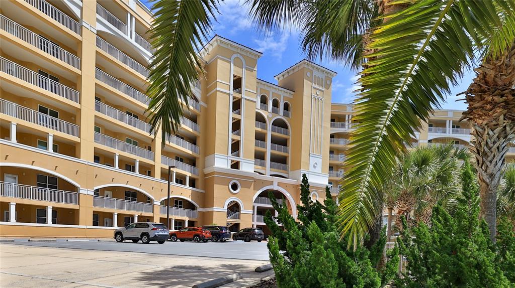 a front view of a multi story building with yard