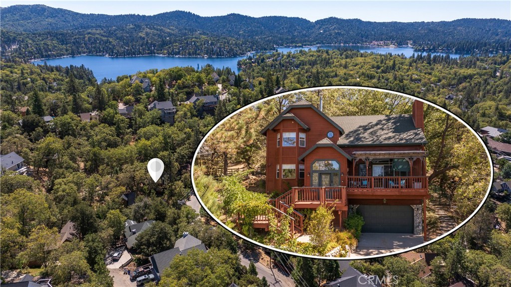 an aerial view of a house with swimming pool and mountains