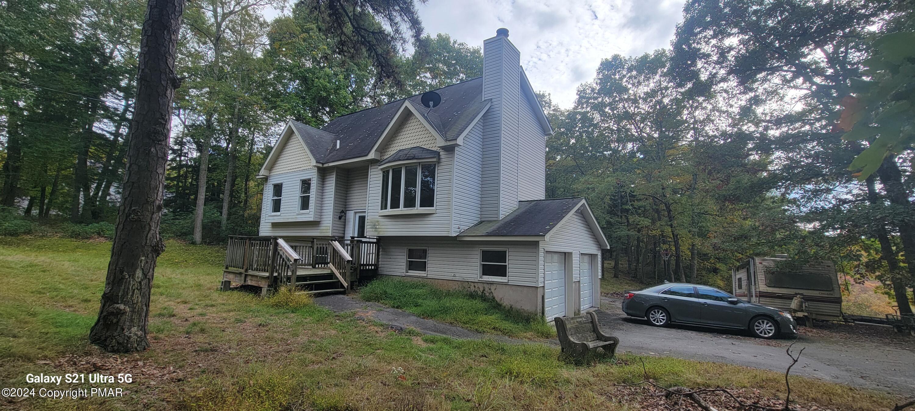 a front view of a house with a garden