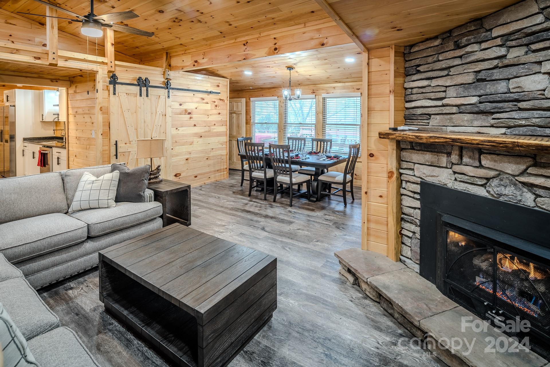 a living room with furniture a fireplace and city view