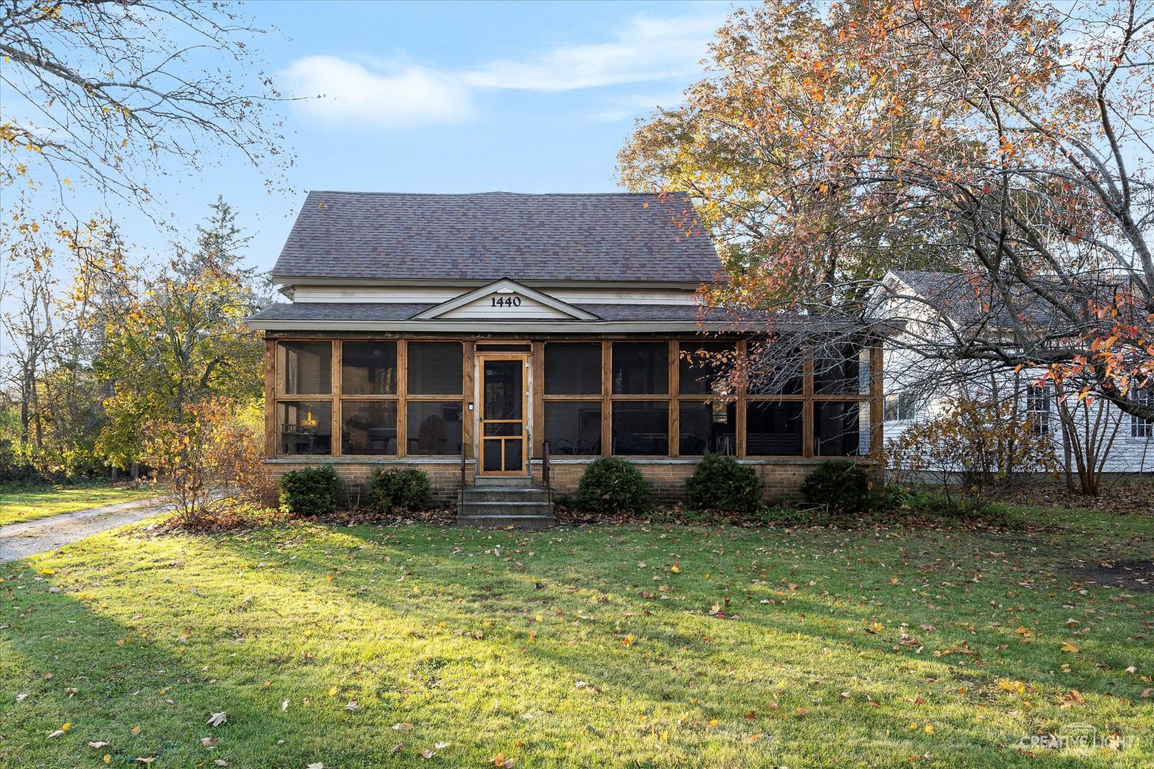 a front view of a house with garden and porch