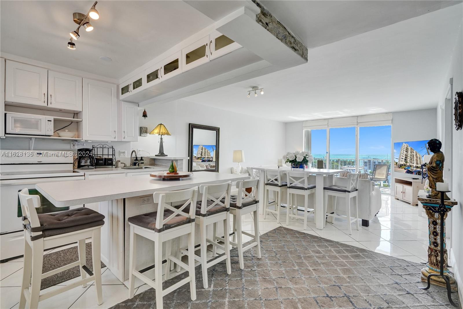 a kitchen with appliances a sink and cabinets