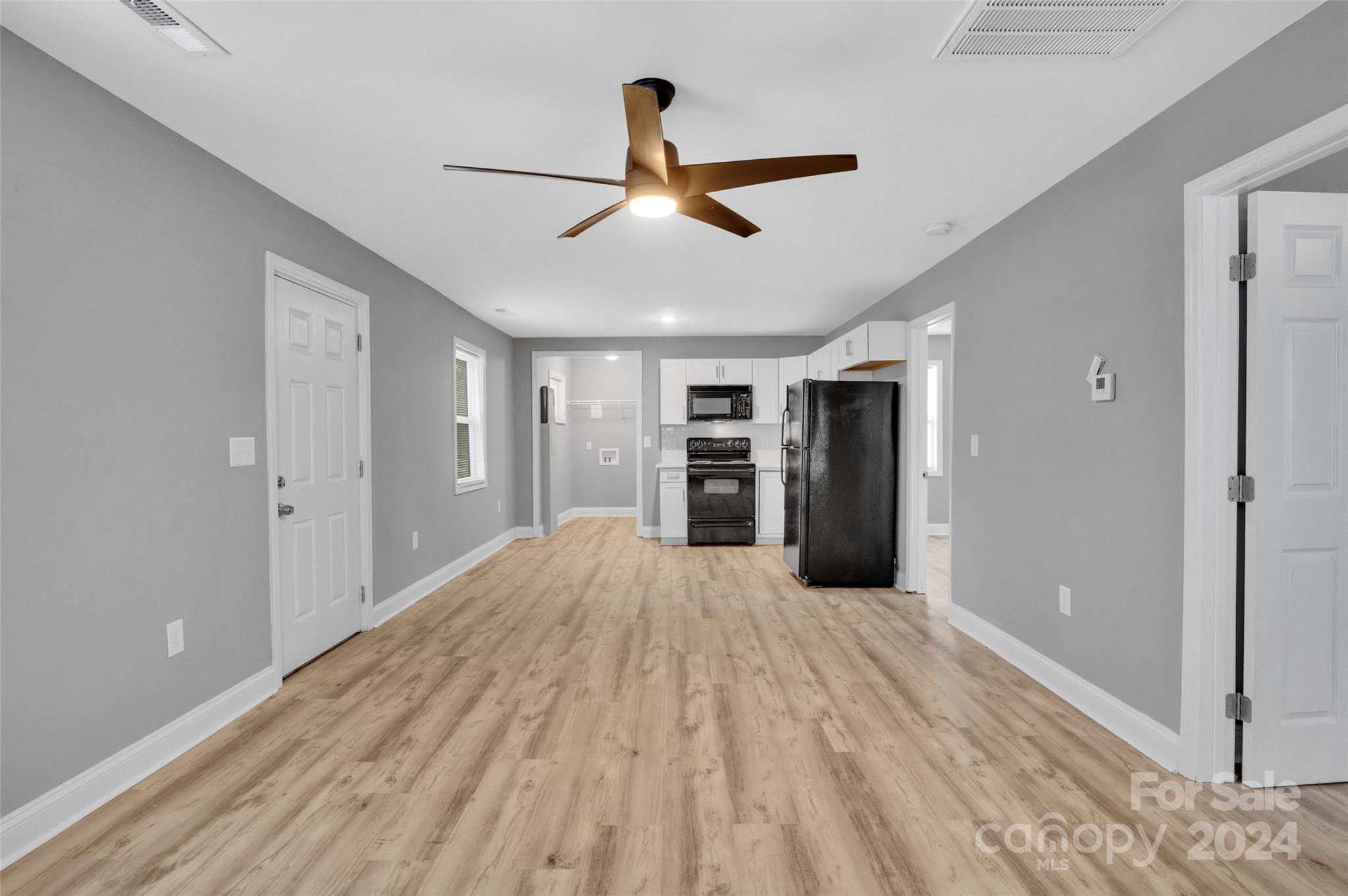 a big room with closet and a ceiling fan