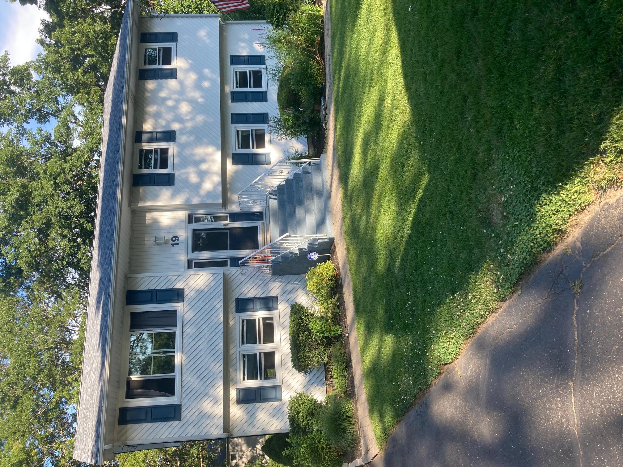 a front view of a house with a yard