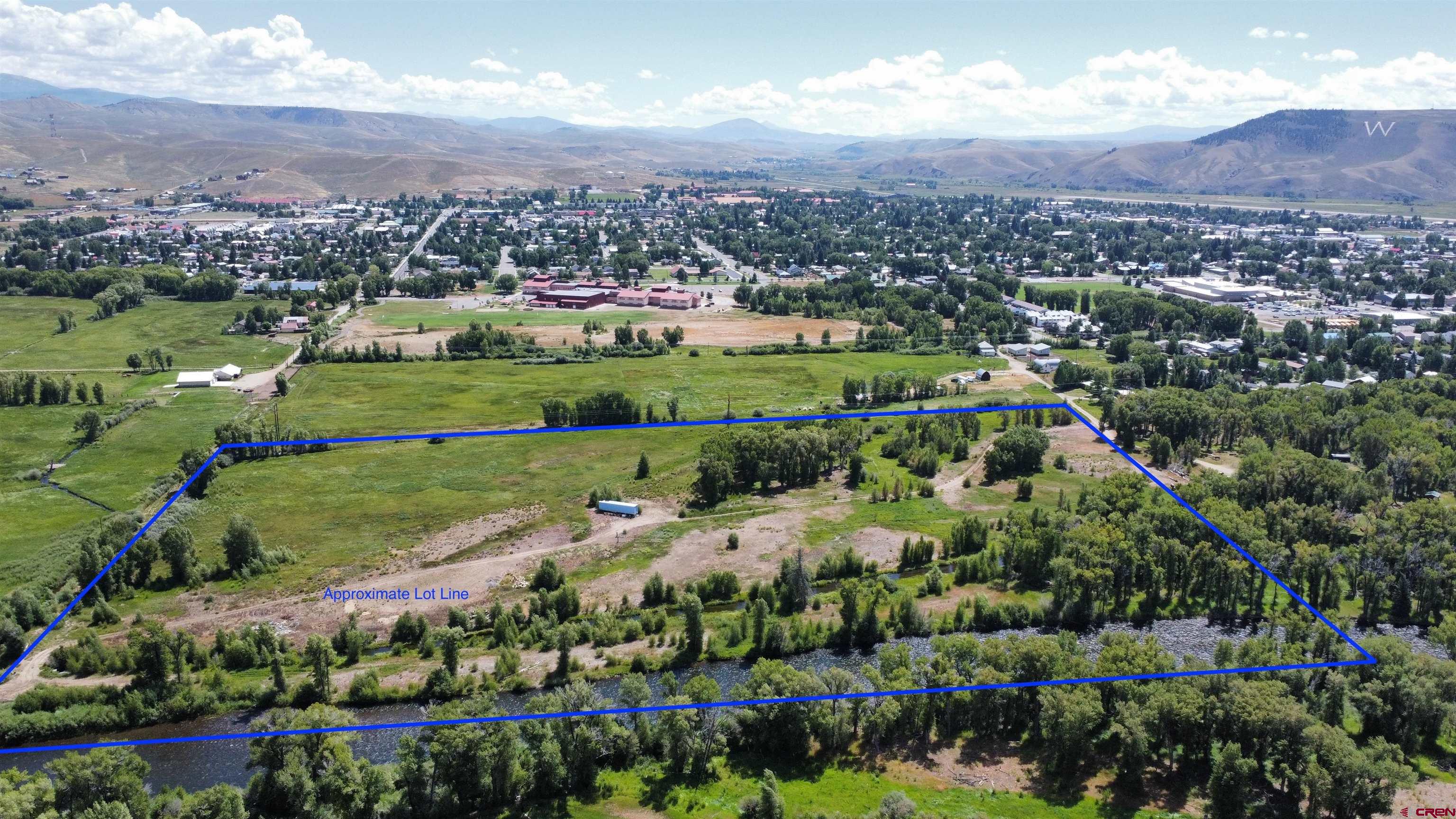 an aerial view of a city with lots of residential buildings and mountain view in back