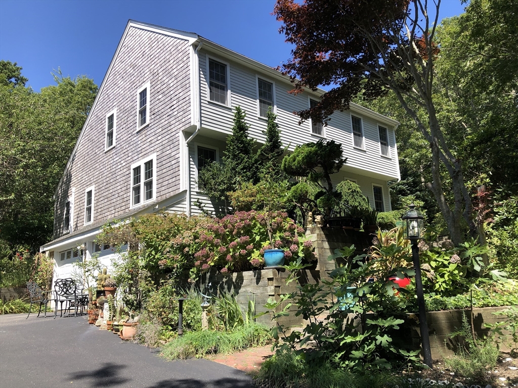 a view of a house with a flower garden