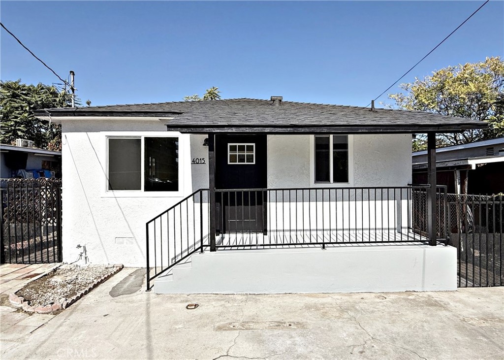 a view of a house with a wooden fence