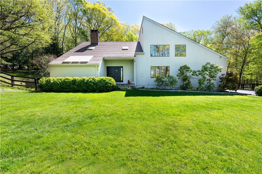 a front view of house with yard and green space