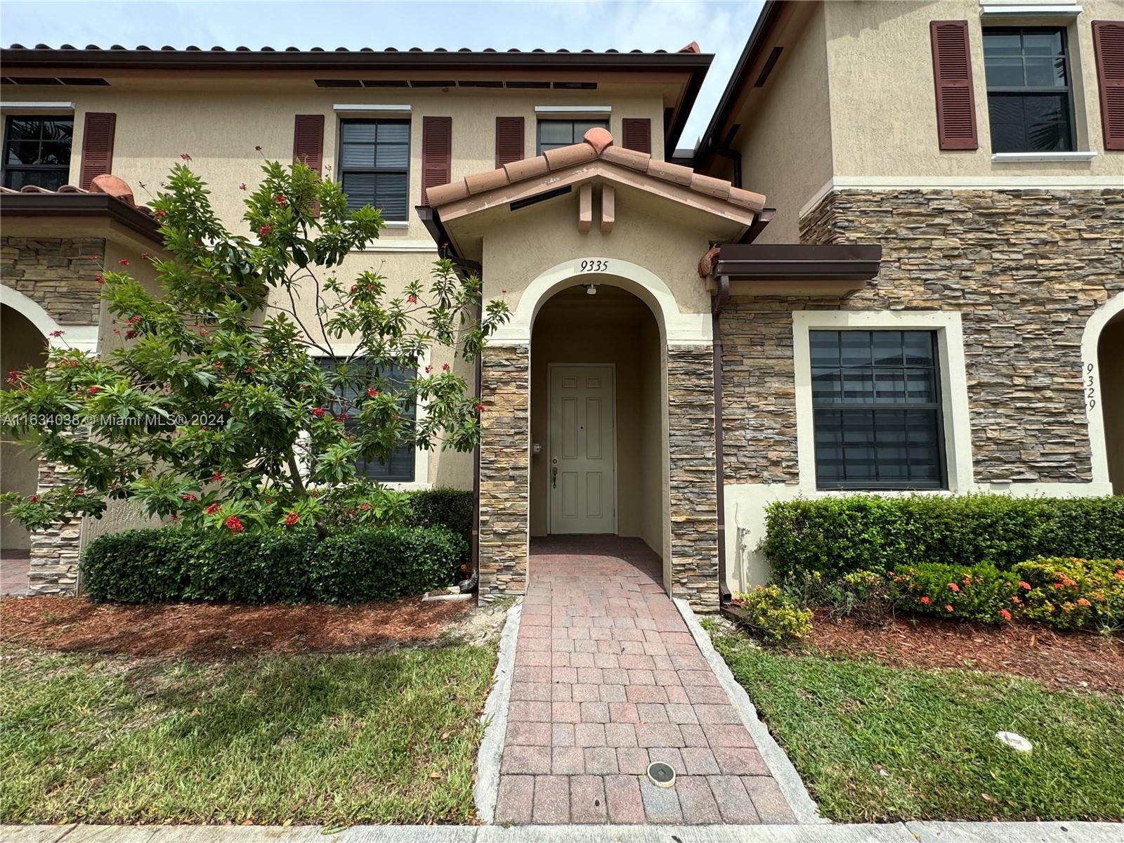 a front view of a house with garden