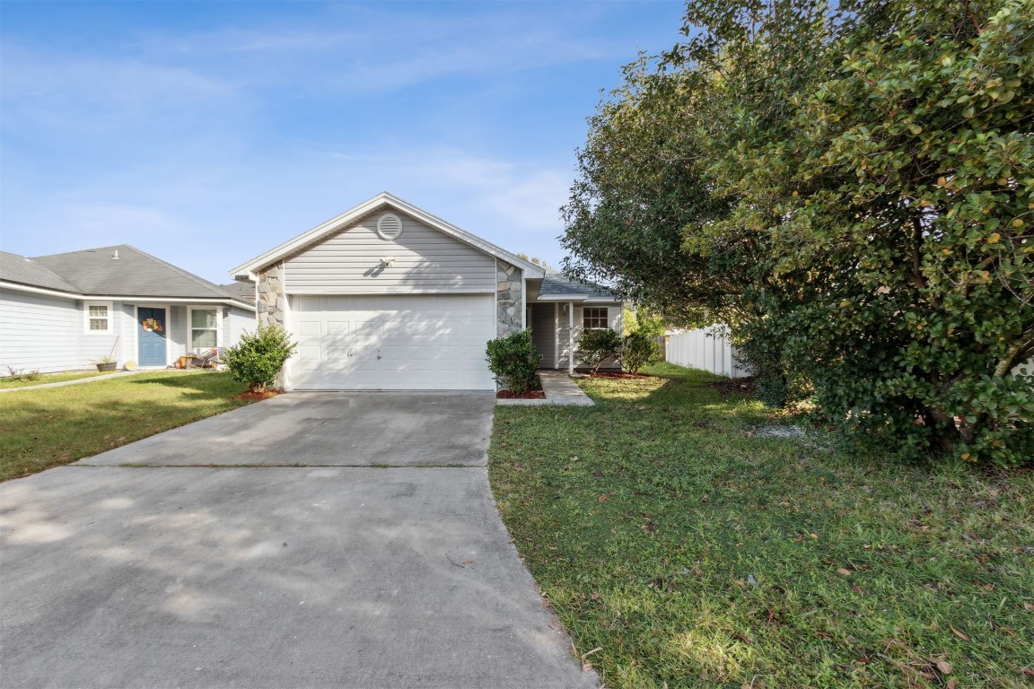 a front view of a house with a yard and garage