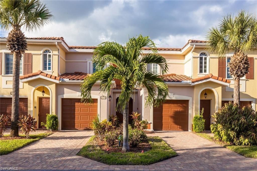 a front view of a house with a yard garage and outdoor seating