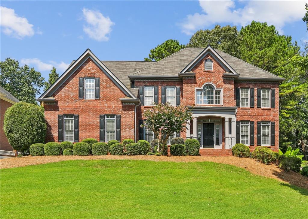 a front view of a house with a yard