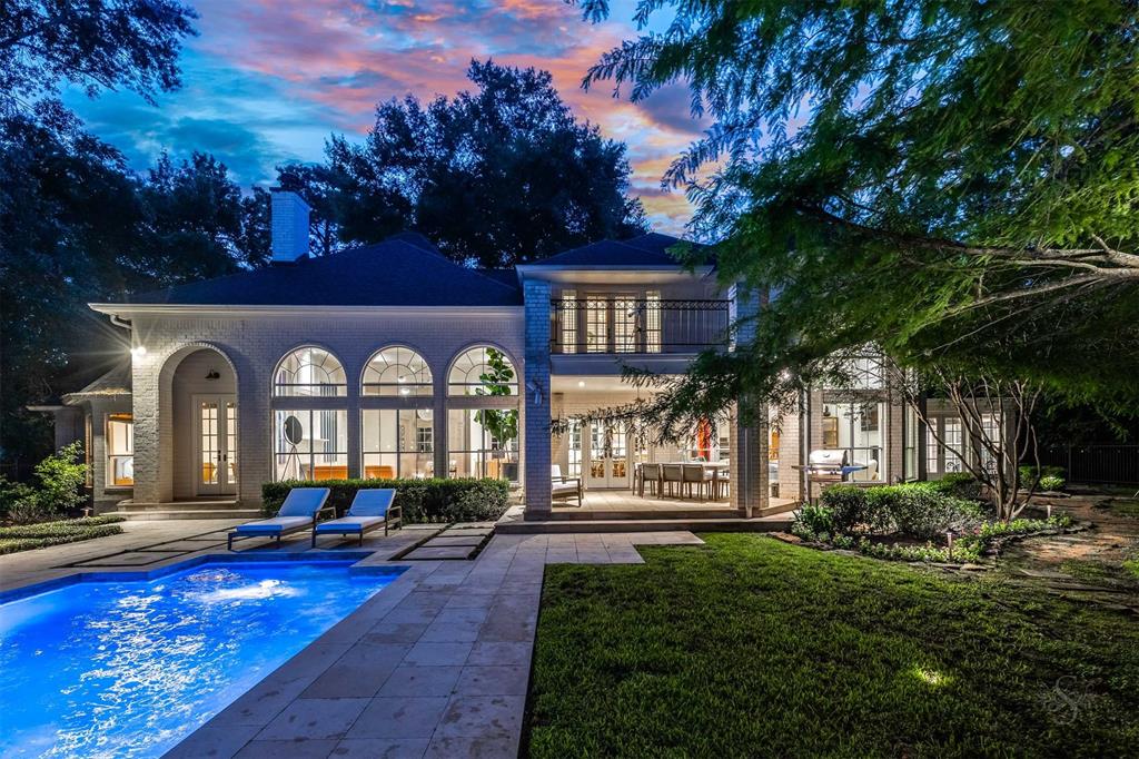 a swimming pool view with a seating space and a garden view