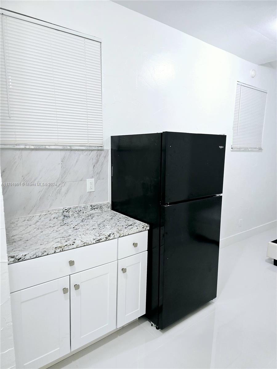 a kitchen with a sink and a refrigerator