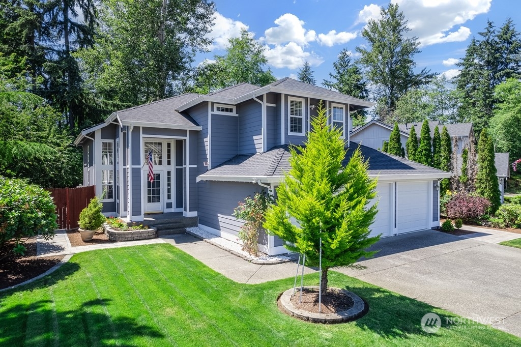 a front view of a house with a yard garage and outdoor seating