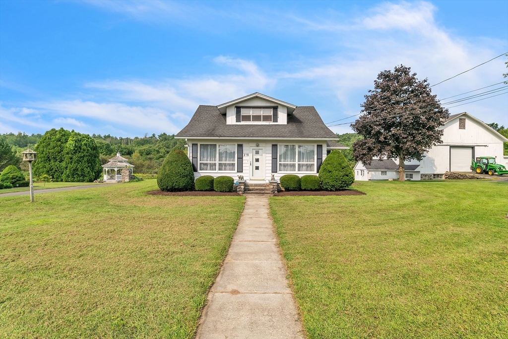 a front view of a house with yard