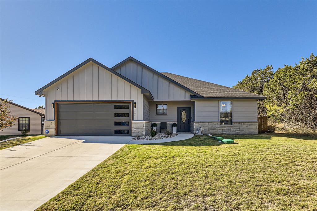 a front view of house with yard outdoor seating and barbeque oven