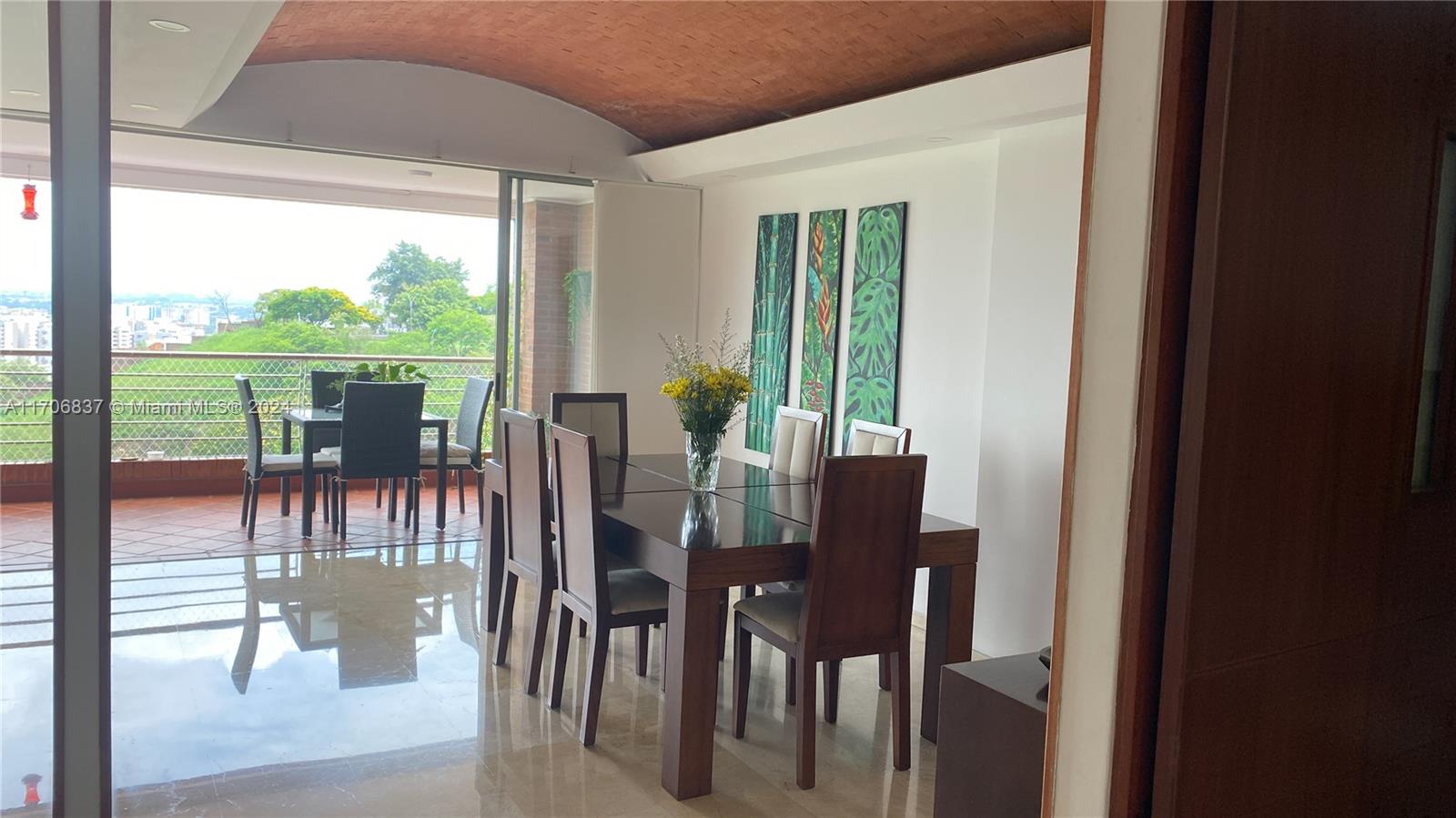 a view of a dining room with furniture window and outside view