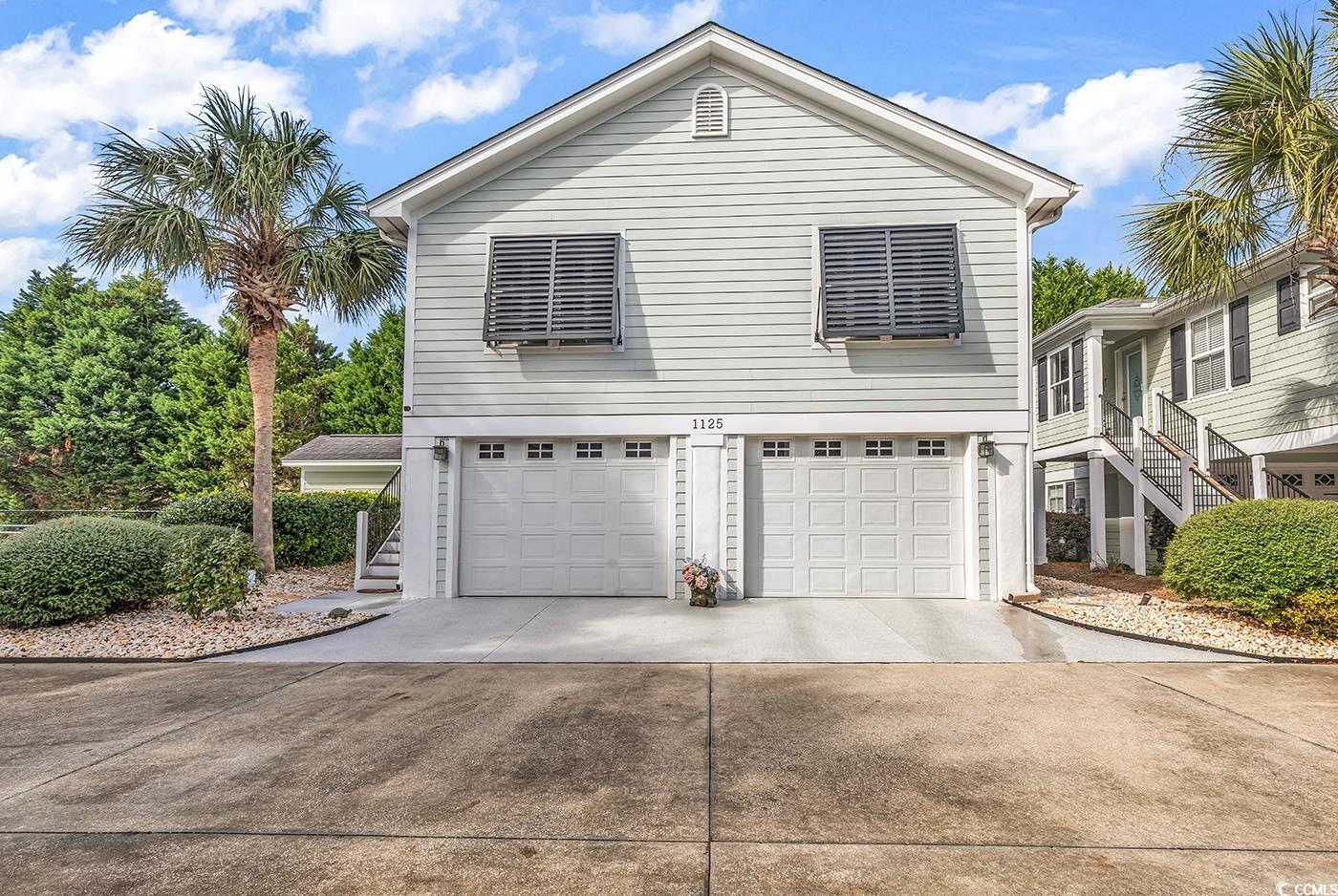 View of side of property featuring a garage