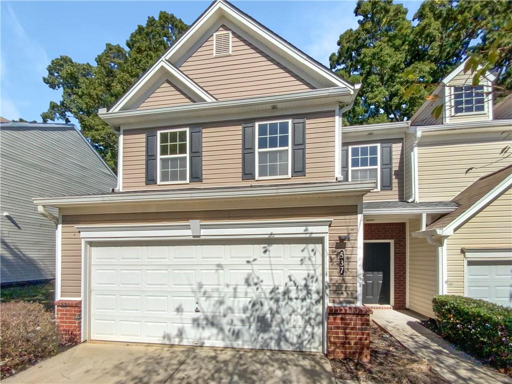 a front view of a house with a garage