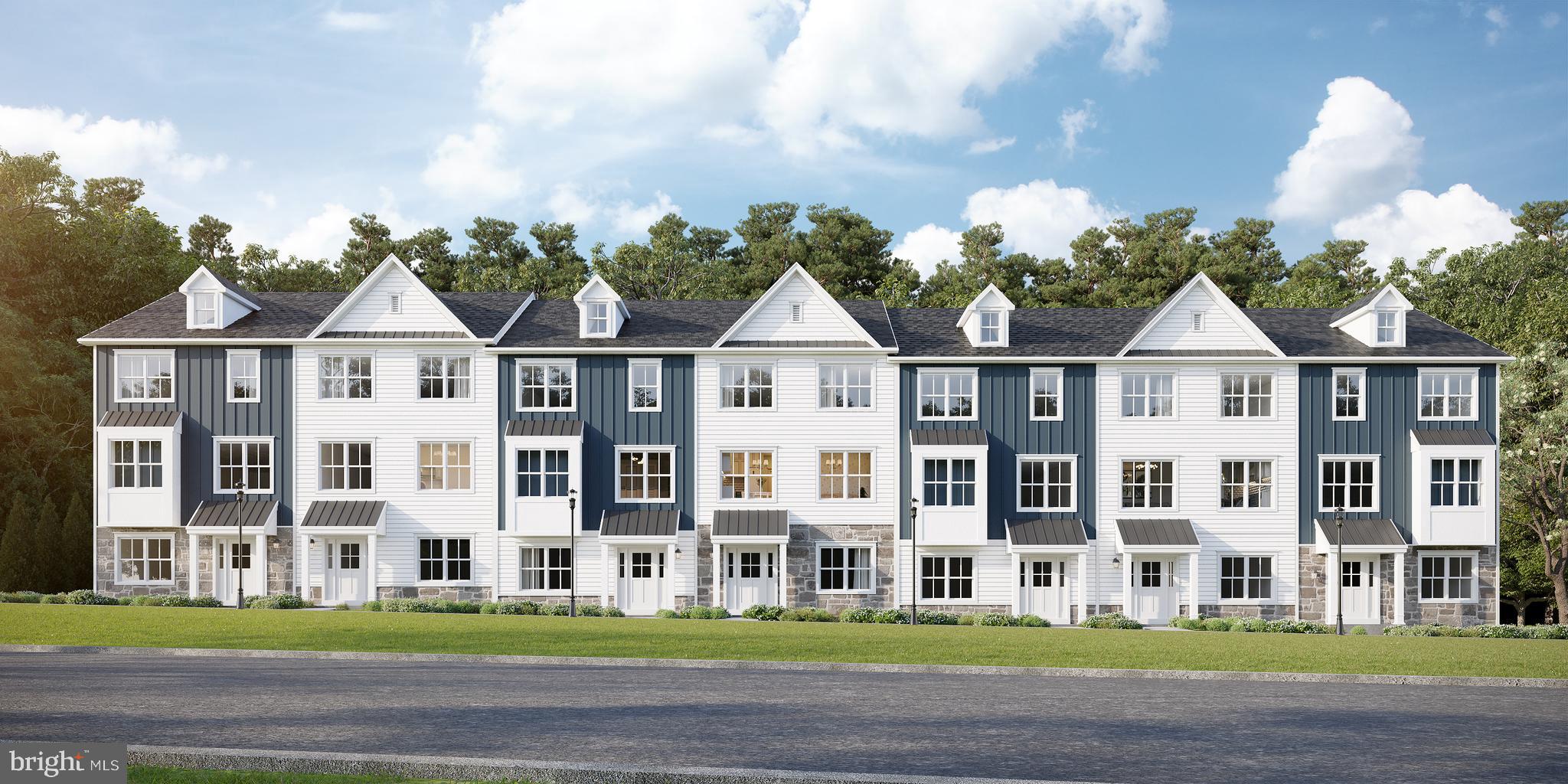 a front view of residential houses with yard and green space