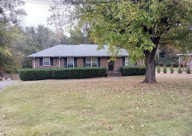 a front view of a house with a yard and a garage