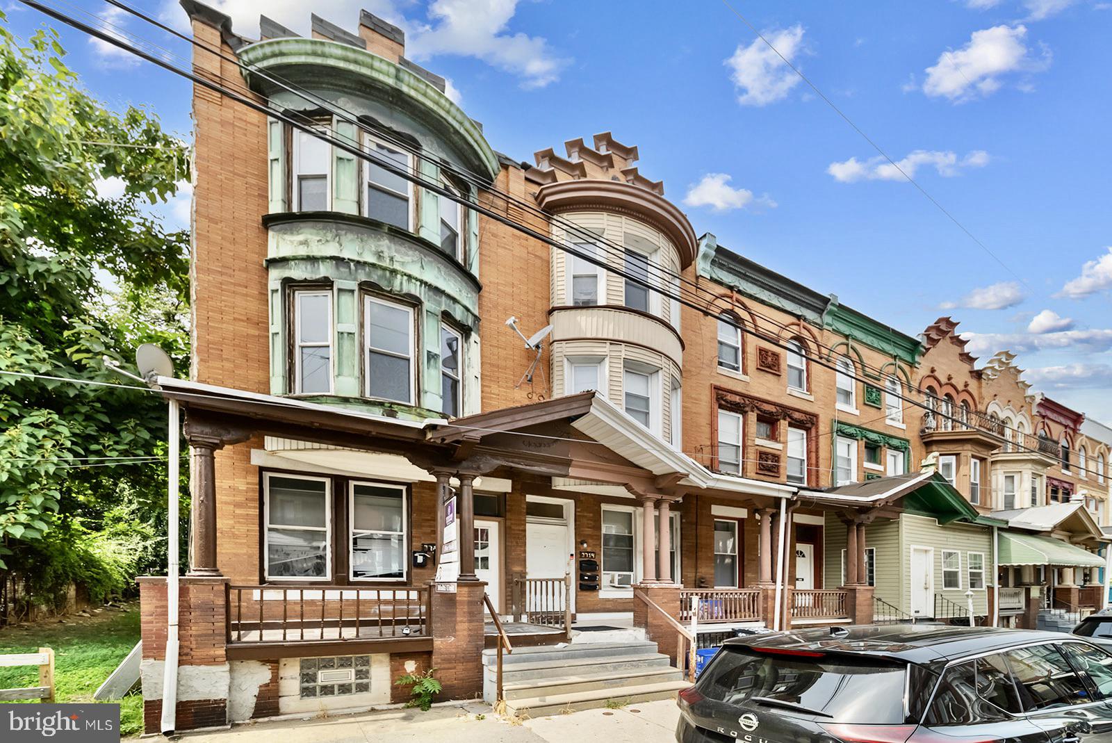 a front view of a residential apartment building with a yard