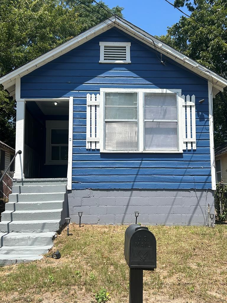 a front view of a house with yard and hallway