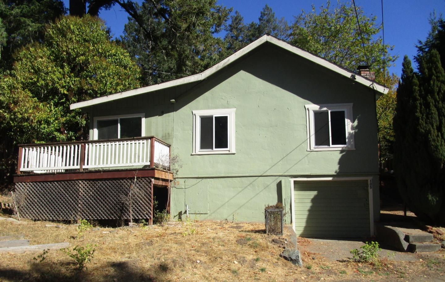 a view of a house with wooden fence and a potted plant