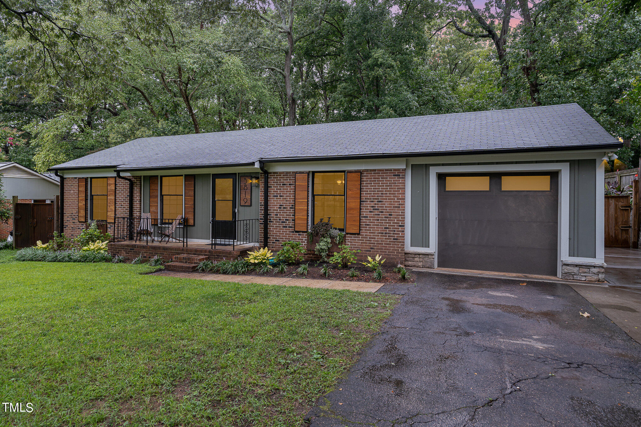 a front view of a house with yard patio and green space