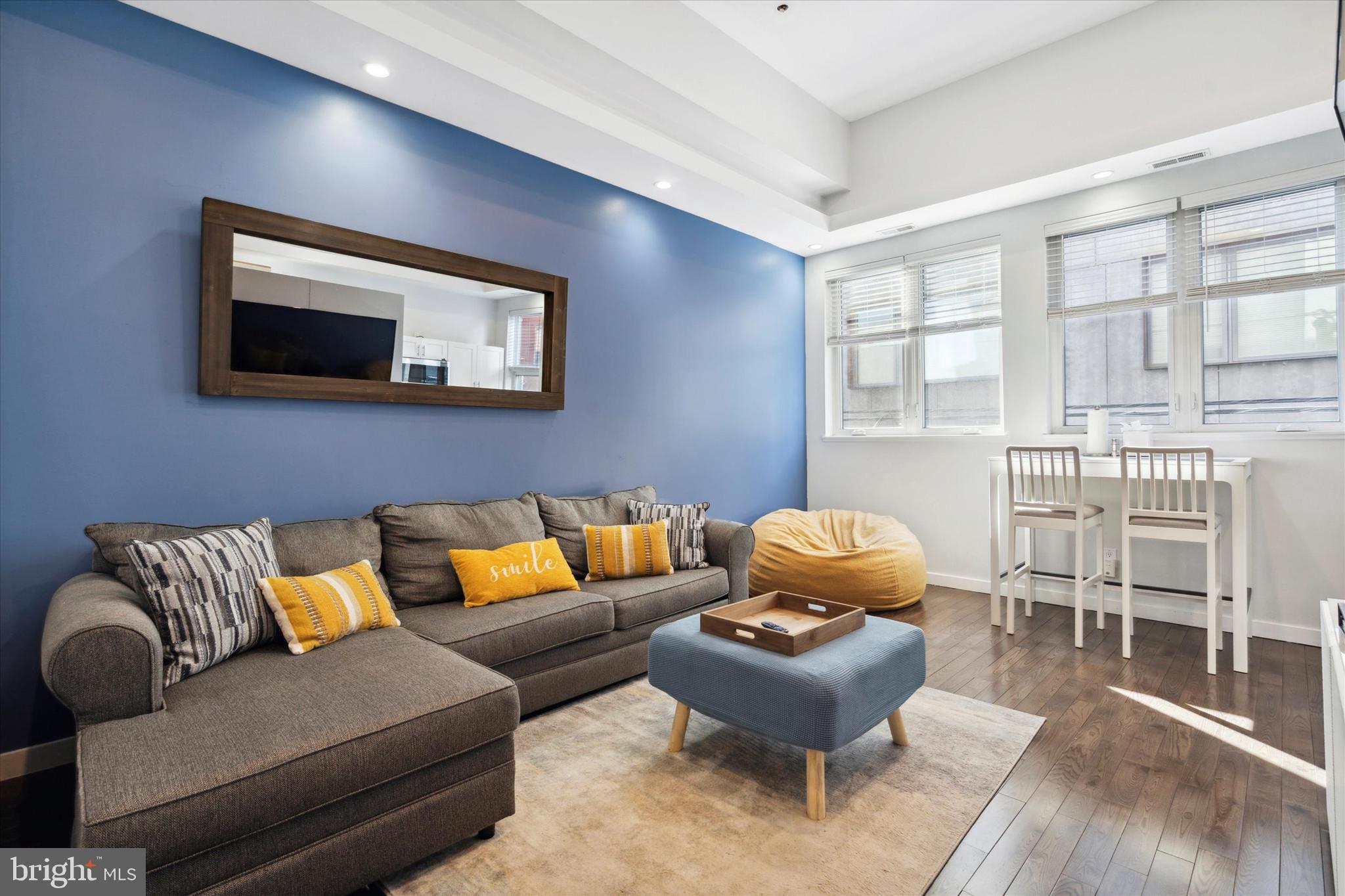 a living room with furniture and a flat screen tv