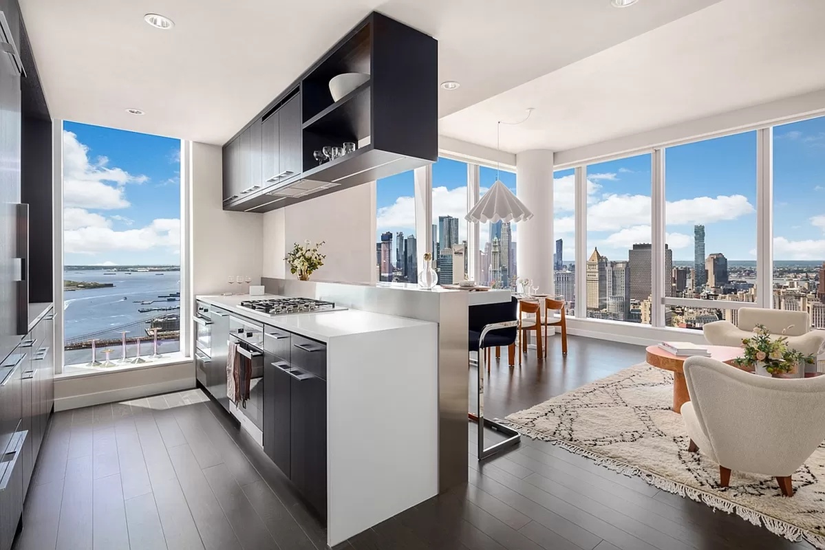 a kitchen with stainless steel appliances granite countertop a stove and a large window