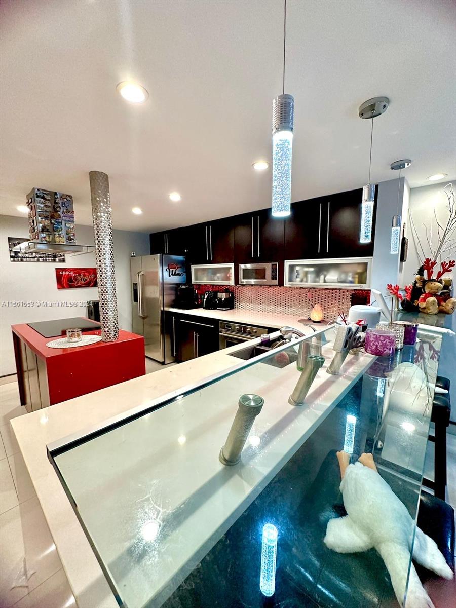 a kitchen with stainless steel appliances wooden cabinets and sink