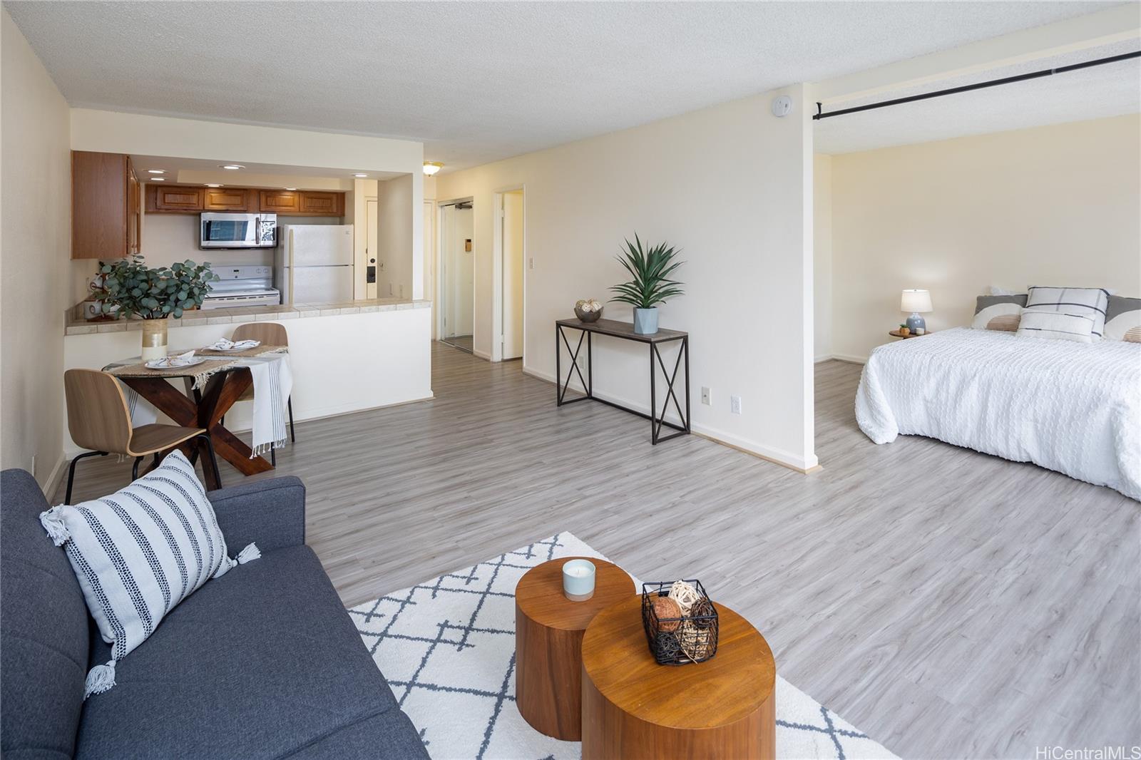 a living room with furniture and wooden floor