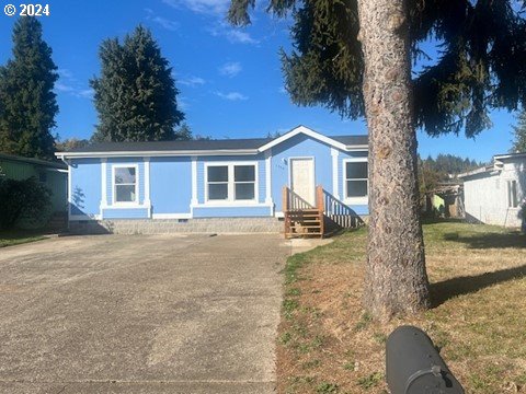 a view of a house with a yard and tree s