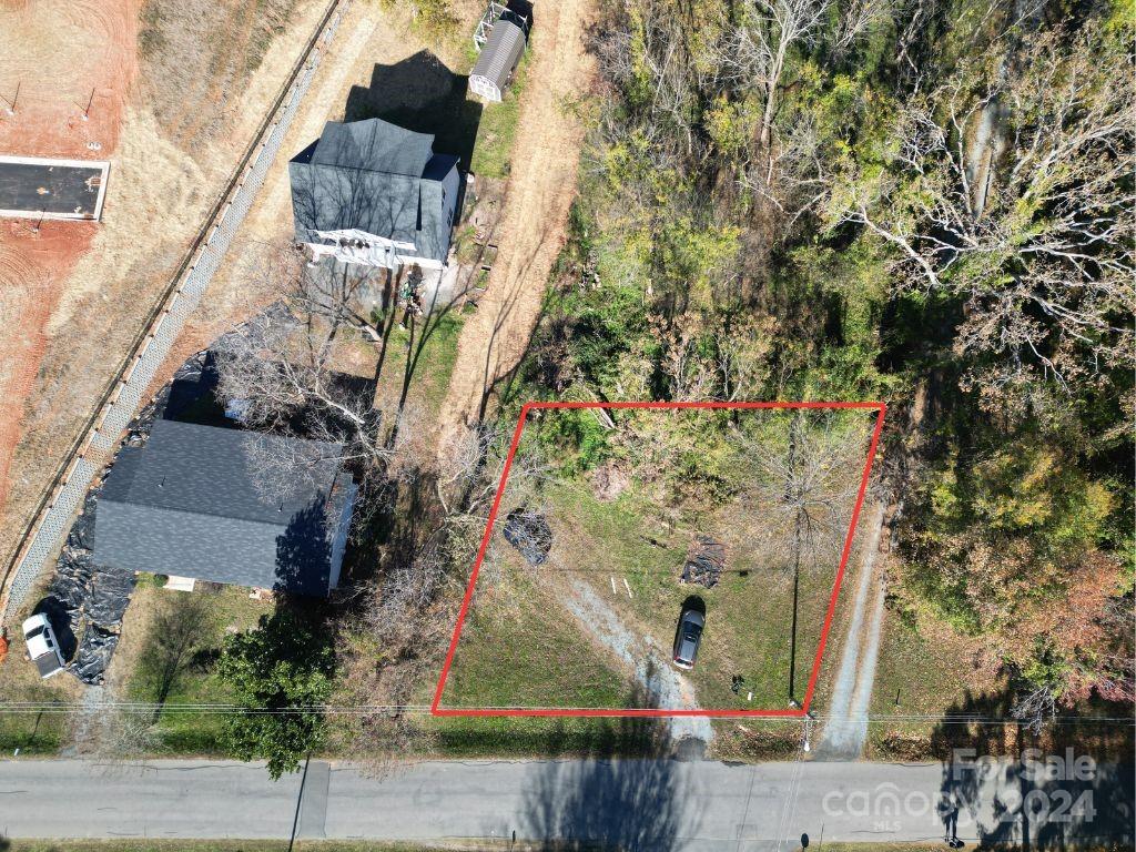 an aerial view of a houses with street