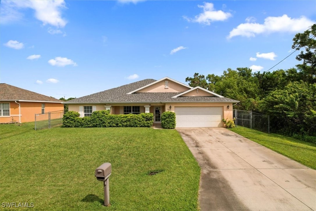 a front view of a house with a yard and garage