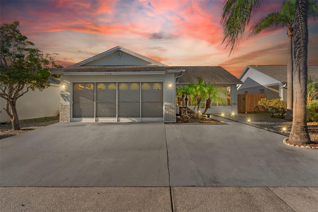 a view of a house with a yard and garage