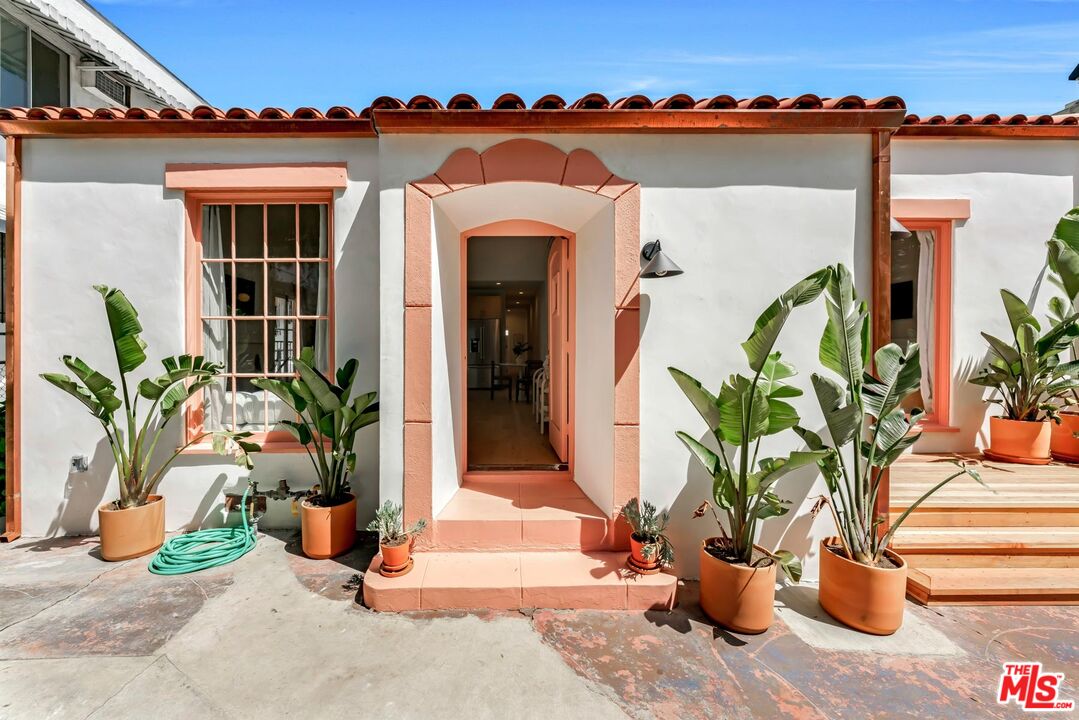 a view of a house with potted plants