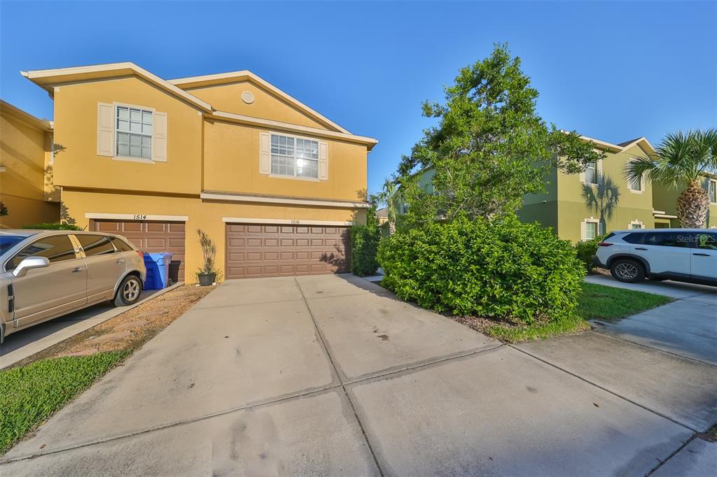 a front view of a house with a yard and garage