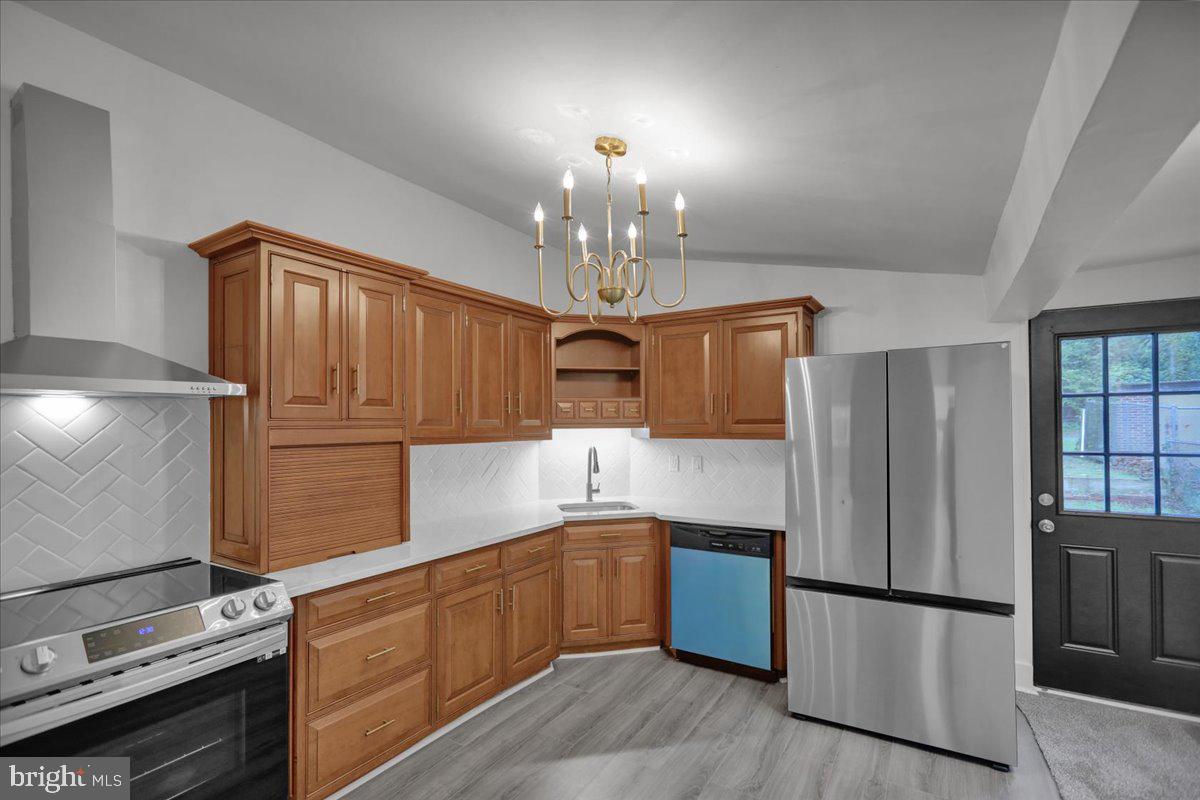 a kitchen with granite countertop stainless steel appliances a counter space and cabinets