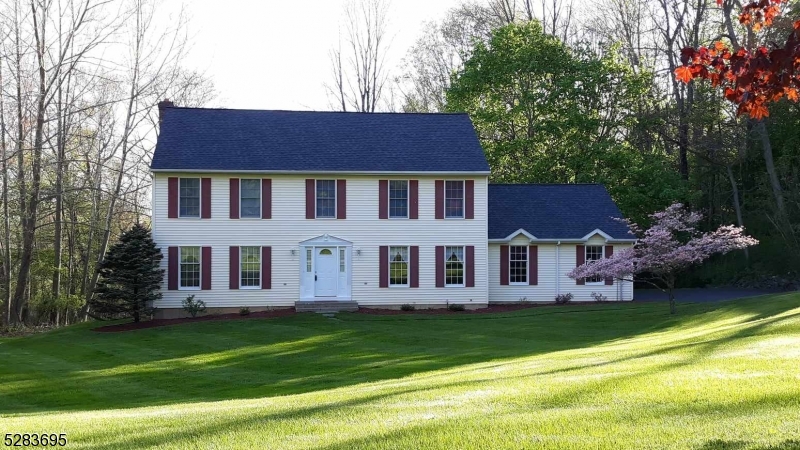 a view of a house with a backyard porch and sitting area