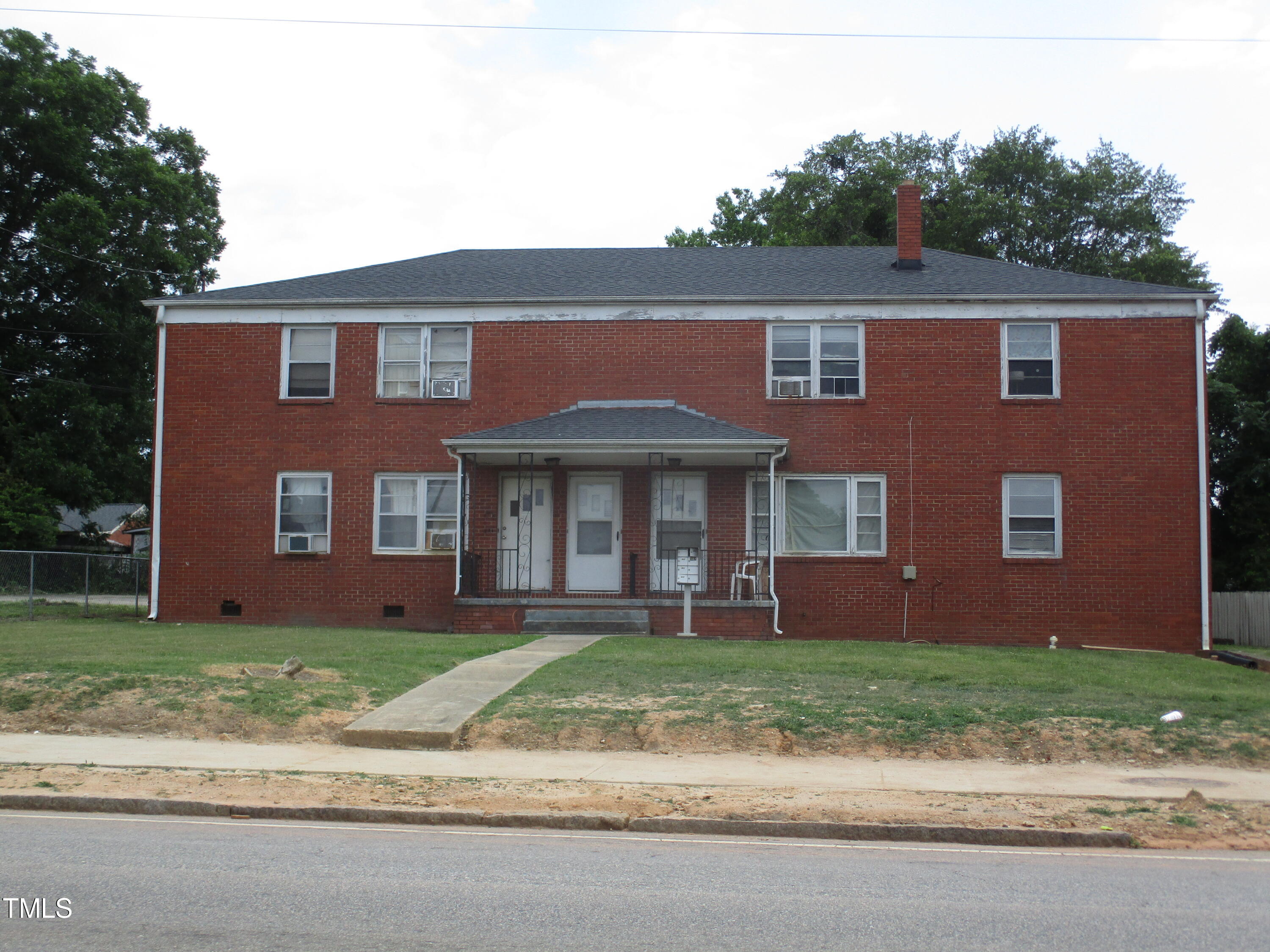 a front view of a house with a yard and a garage