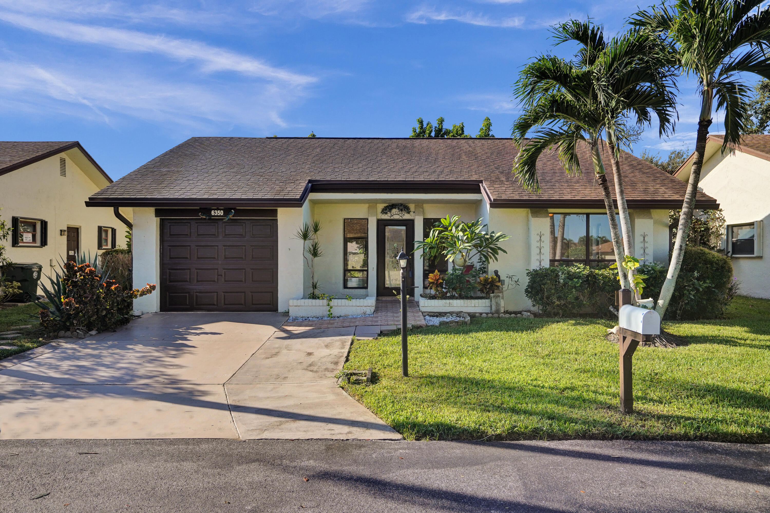 a front view of a house with garden and porch