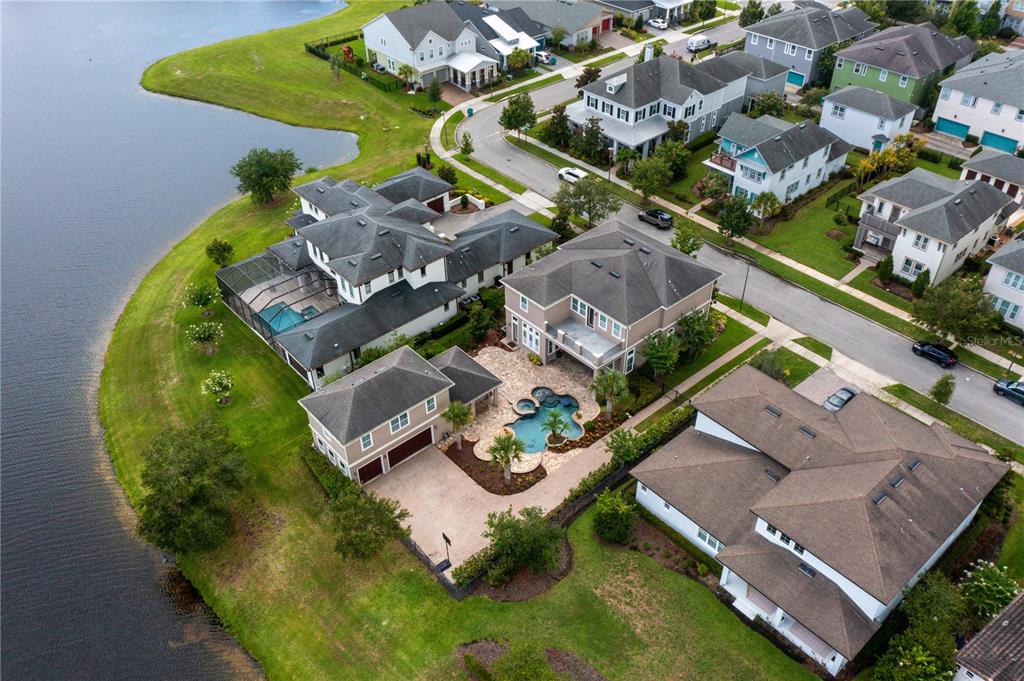 an aerial view of a house with a swimming pool yard and outdoor seating